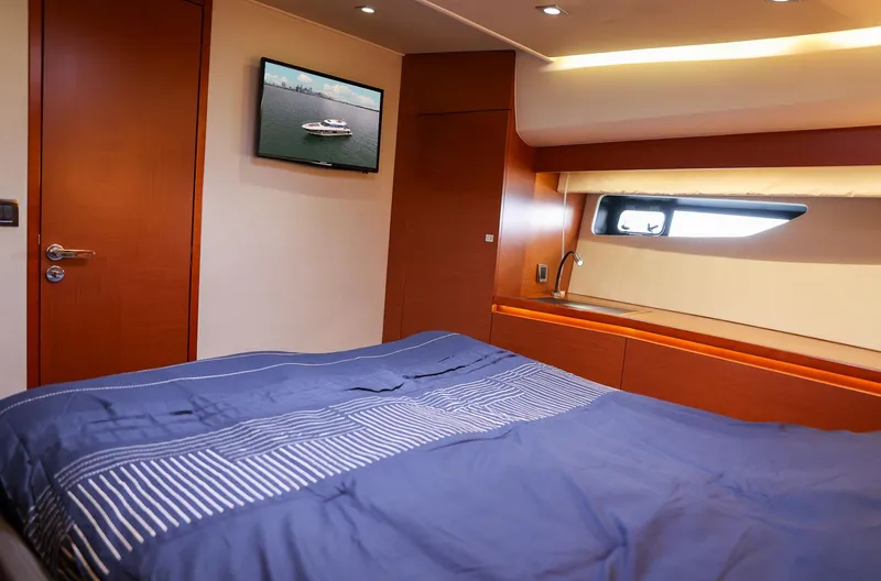  Yacht Photos Pics Luxurious cabin interior of 2015 Prestige 520 yacht with cozy bedding and modern amenities.