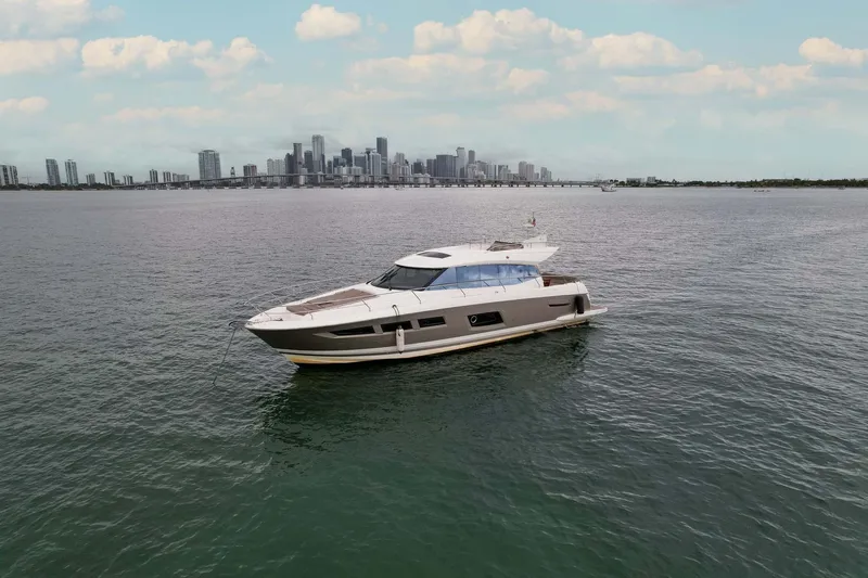 Yacht Photos Pics Prestige 520 yacht cruising on open water with city skyline in the background, 2015 model.