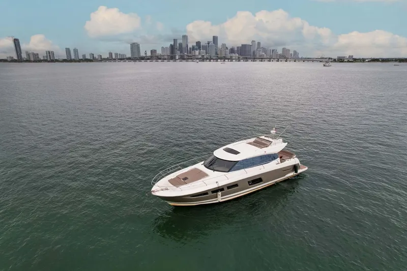  Yacht Photos Pics Prestige 520 yacht on water with city skyline in background, 2015 model.