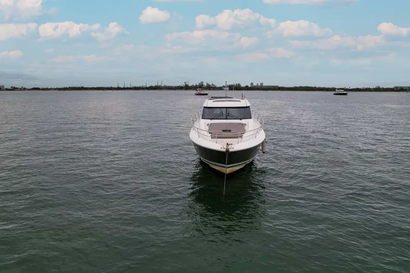  Yacht Photos Pics 2015 Prestige 520 yacht on calm water under a partly cloudy sky.