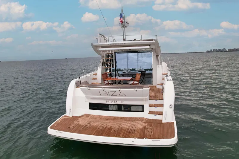  Yacht Photos Pics Luxury 2015 Prestige 520 yacht on open water, featuring spacious deck and elegant design.