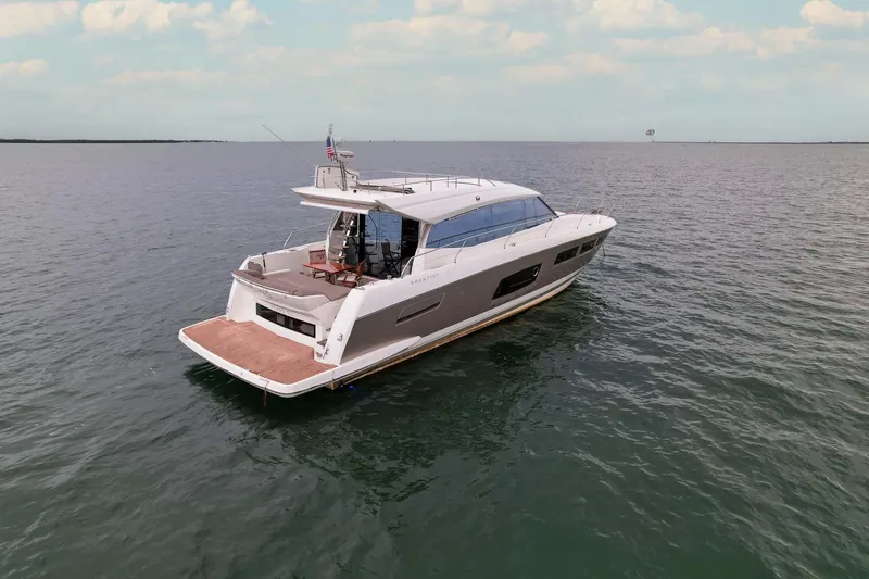  Yacht Photos Pics Luxury 2015 Prestige 520 yacht cruising on open water under a clear sky.