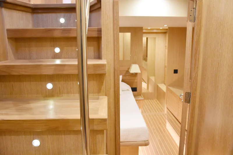  Yacht Photos Pics Luxurious interior of 2026 Sasga Yachts Menorquin 68, featuring elegant wooden staircase and cozy cabin.