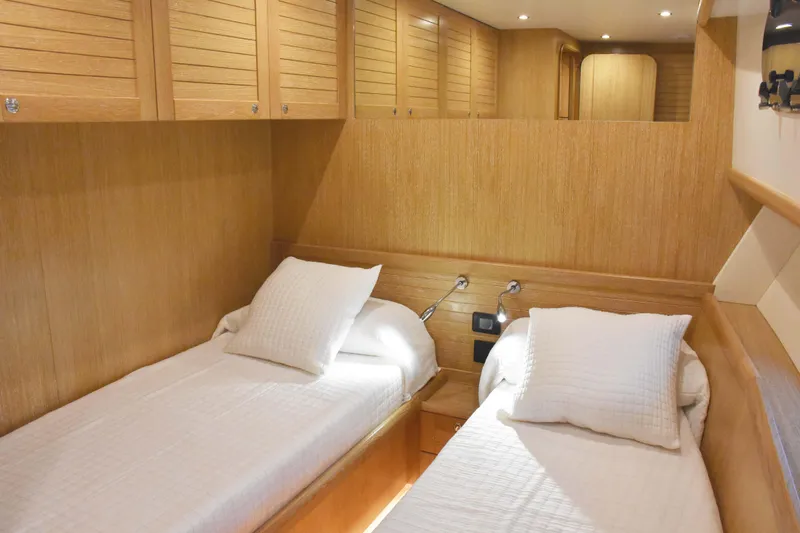  Yacht Photos Pics Interior cabin of 2026 Sasga Yachts Menorquin 68 with twin beds and wooden finish.