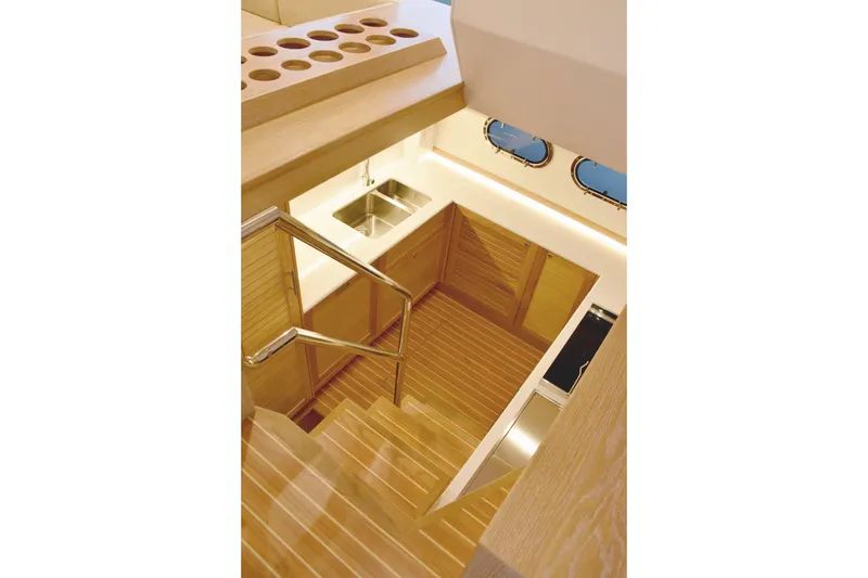  Yacht Photos Pics Interior of 2026 Sasga Yachts Menorquin 68, featuring wooden stairs and modern kitchen area.