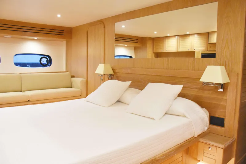  Yacht Photos Pics Luxurious interior of 2026 Sasga Yachts Menorquin 68 with elegant wood finish and cozy bedding.