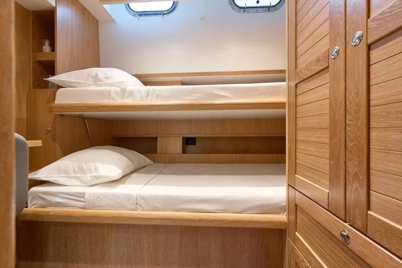  Yacht Photos Pics Bunk beds in 2026 Sasga Yachts Menorquin 68 cabin, featuring wooden interior design.