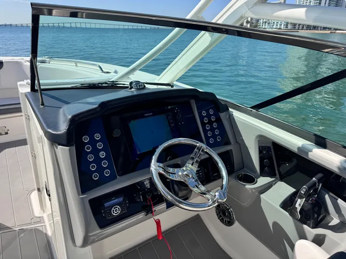  Yacht Photos Pics 2021 Robalo R317 Dual Console boat dashboard with steering wheel and navigation system.