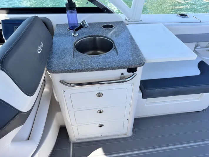  Yacht Photos Pics 2021 Robalo R317 Dual Console boat interior with sink and storage drawers.