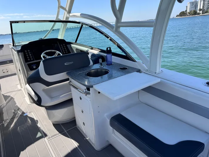  Yacht Photos Pics 2021 Robalo R317 Dual Console boat interior with helm, seating, and sink by the water.