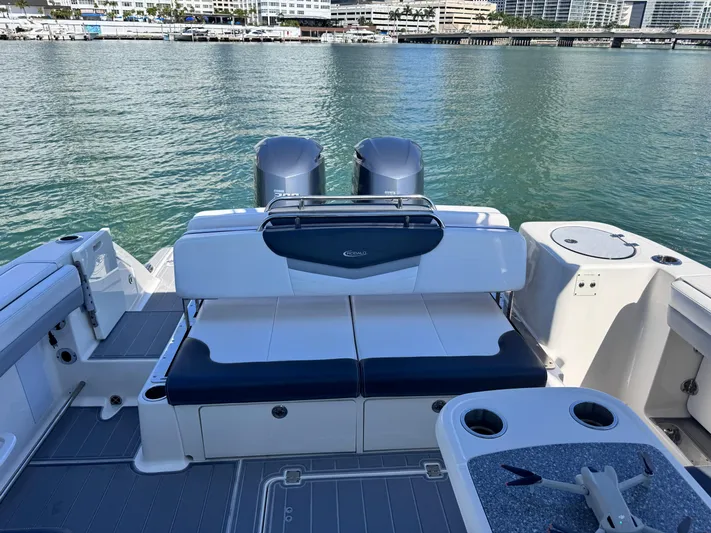  Yacht Photos Pics 2021 Robalo R317 Dual Console boat interior with seating and ocean view.