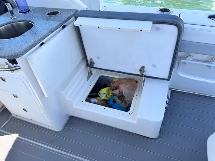  Yacht Photos Pics 2021 Robalo R317 Dual Console boat with open storage compartment and sink.