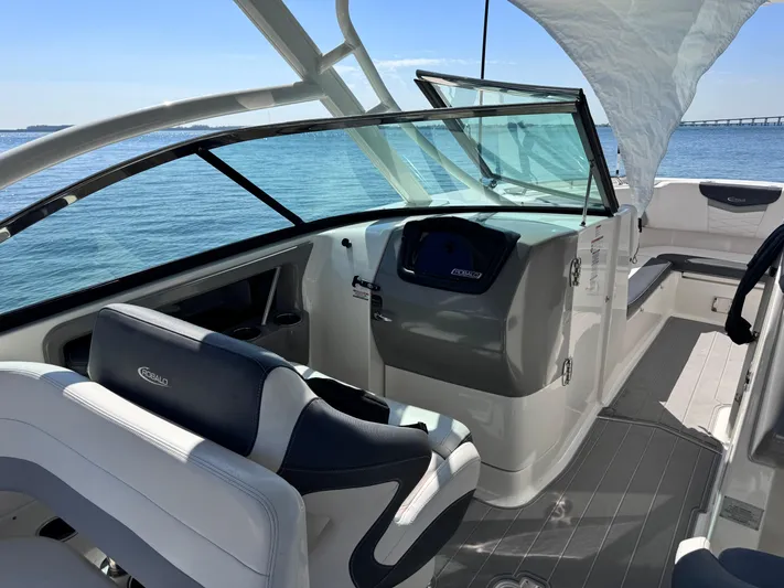  Yacht Photos Pics 2021 Robalo R317 Dual Console boat interior with helm, seating, and ocean view.