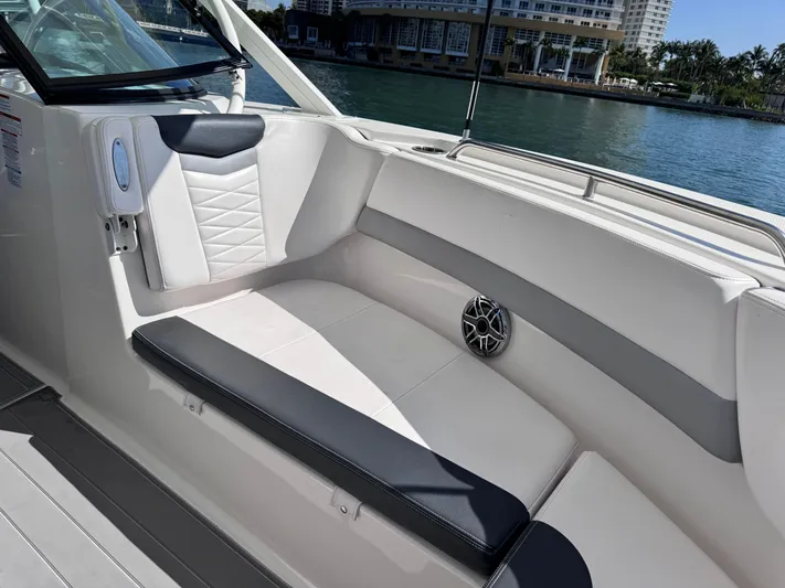  Yacht Photos Pics 2021 Robalo R317 Dual Console boat interior with cushioned seating and speaker.