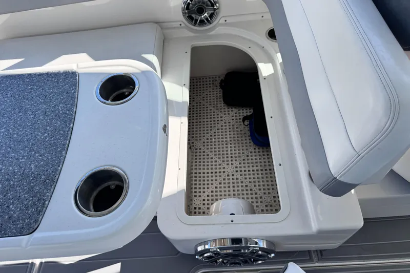  Yacht Photos Pics 2021 Robalo R317 Dual Console boat interior with storage compartment and cup holders.
