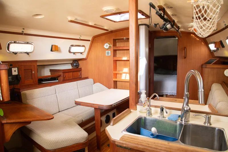 Harvest Moon Yacht Photos Pics Interior of 1999 Island Packet 380 sailboat with cozy seating and kitchen area.