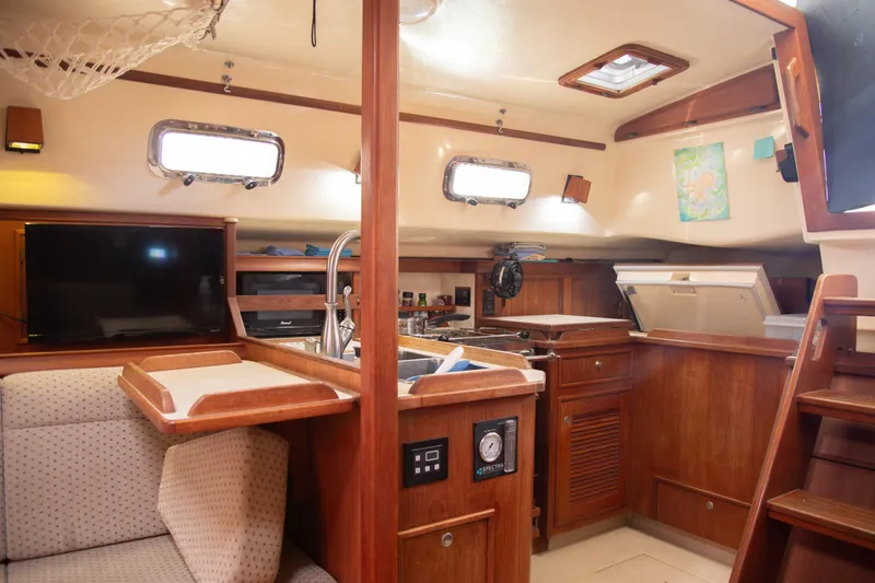 Harvest Moon Yacht Photos Pics Interior of 1999 Island Packet 380 sailboat with cozy seating and wooden cabinetry.