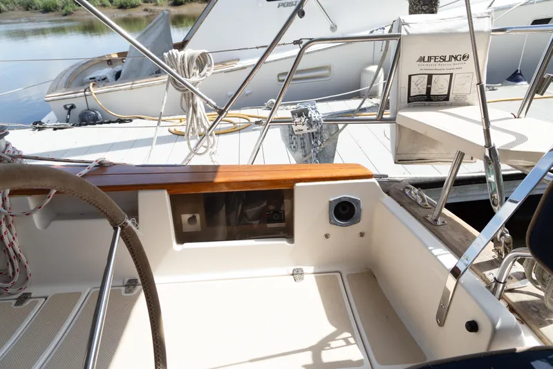 Harvest Moon Yacht Photos Pics Cockpit of 1999 Island Packet 380 sailboat with steering wheel and lifebuoy.
