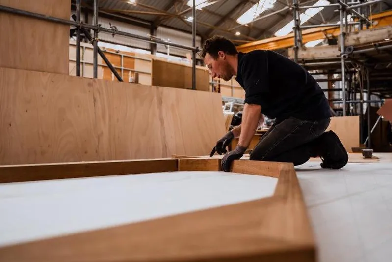 Gwenhyfar II Yacht Photos Pics Man working on wooden frame in workshop, Spirit C72, 2023.