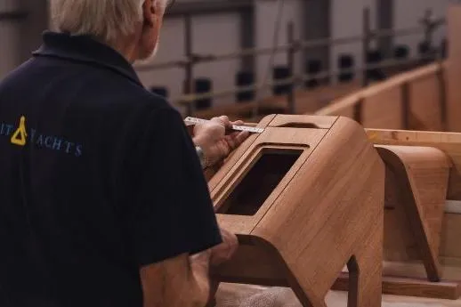 Gwenhyfar II Yacht Photos Pics Craftsman measuring wooden component for 2023 Spirit C72 yacht construction.