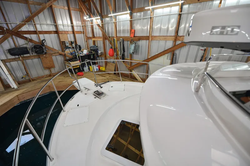 Celtic Mist Yacht Photos Pics 2023 Ranger Tugs R-29S in a wooden boathouse, showcasing deck and equipment.