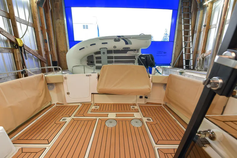 Celtic Mist Yacht Photos Pics 2023 Ranger Tugs R-29S boat interior with teak flooring and covered seating.