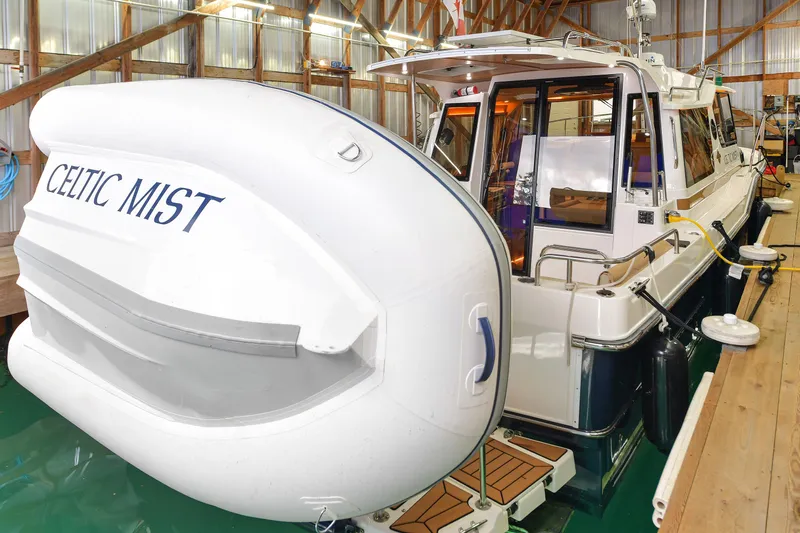 Celtic Mist Yacht Photos Pics 2023 Ranger Tugs R-29S boat "Celtic Mist" docked in a wooden boathouse.