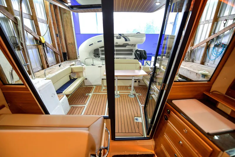 Celtic Mist Yacht Photos Pics 2023 Ranger Tugs R-29S interior with wood finish and seating area.