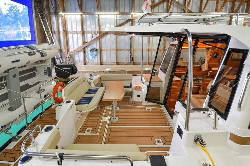 Celtic Mist Yacht Photos Pics 2023 Ranger Tugs R-29S boat interior with seating and wooden flooring in a boathouse.