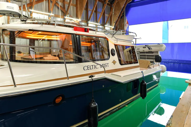 Celtic Mist Yacht Photos Pics 2023 Ranger Tugs R-29S boat docked indoors with vibrant lighting.