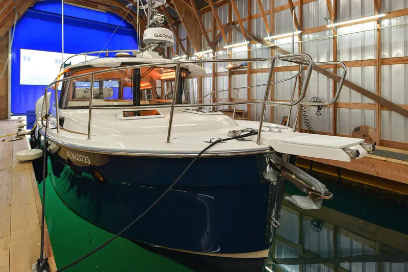 Celtic Mist Yacht Photos Pics 2023 Ranger Tugs R-29S boat docked in a wooden boathouse.