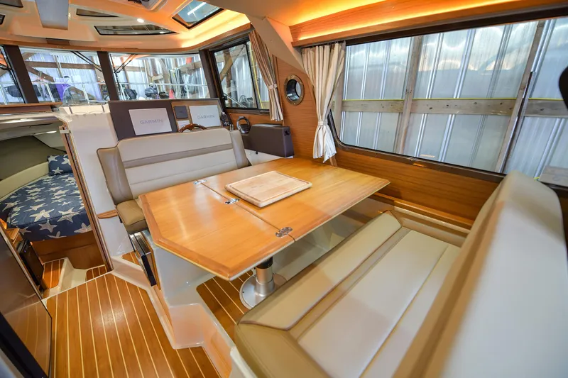 Celtic Mist Yacht Photos Pics 2023 Ranger Tugs R-29S interior with dining area and navigation equipment.