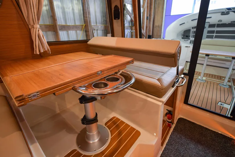 Celtic Mist Yacht Photos Pics 2023 Ranger Tugs R-29S interior with wooden table and seating area.