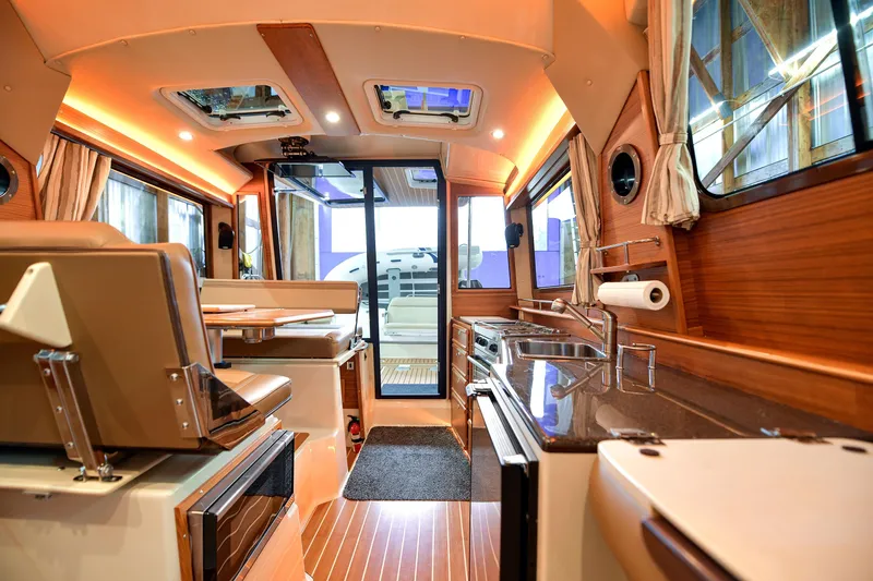 Celtic Mist Yacht Photos Pics Interior of 2023 Ranger Tugs R-29S, featuring modern kitchen and seating area.