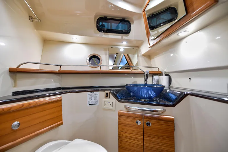 Celtic Mist Yacht Photos Pics 2023 Ranger Tugs R-29S bathroom with modern sink and wooden cabinetry.