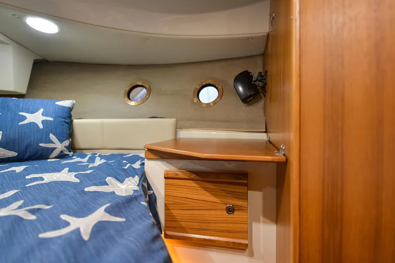Celtic Mist Yacht Photos Pics Cozy cabin interior of 2023 Ranger Tugs R-29S with starfish bedding and wooden accents.