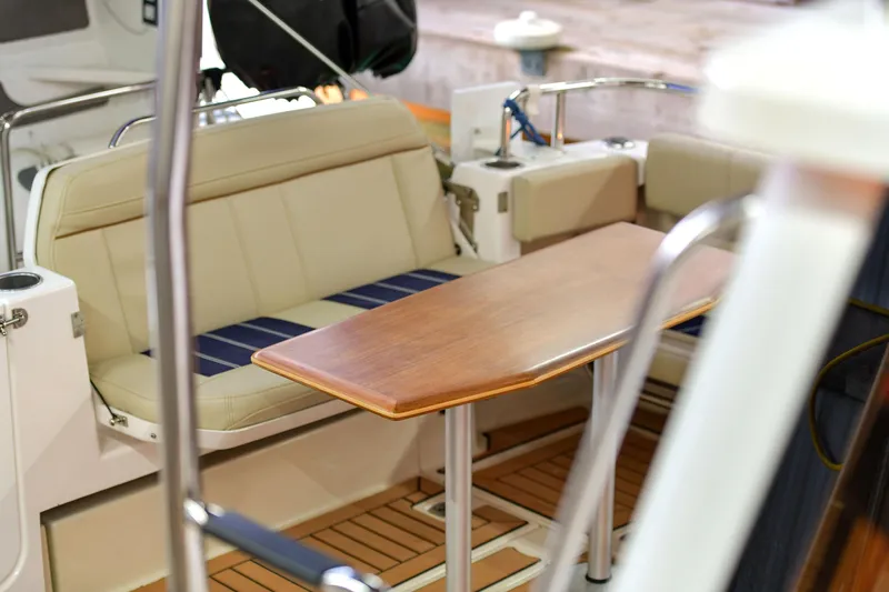 Celtic Mist Yacht Photos Pics 2023 Ranger Tugs R-29S interior with wooden table and cushioned seating.
