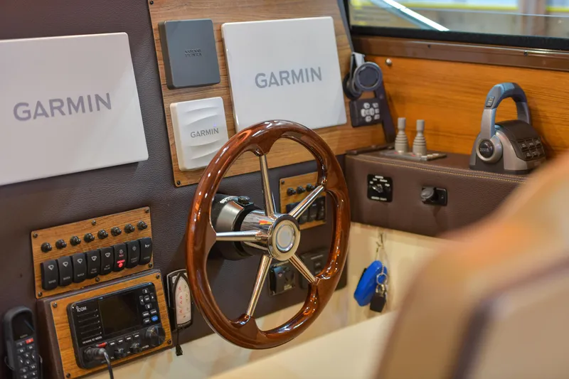 Celtic Mist Yacht Photos Pics 2023 Ranger Tugs R-29S helm with Garmin navigation and wooden steering wheel.