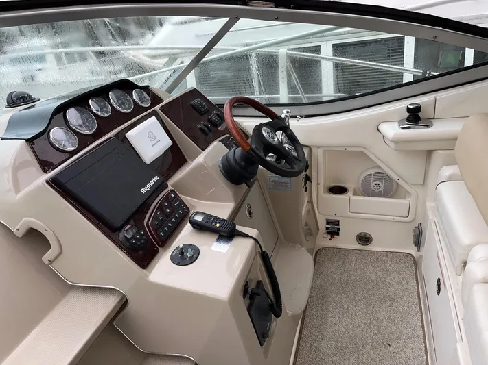 Blue Aye Yacht Photos Pics Cockpit of a 2008 Sea Ray 330 Sundancer with steering wheel and navigation controls.