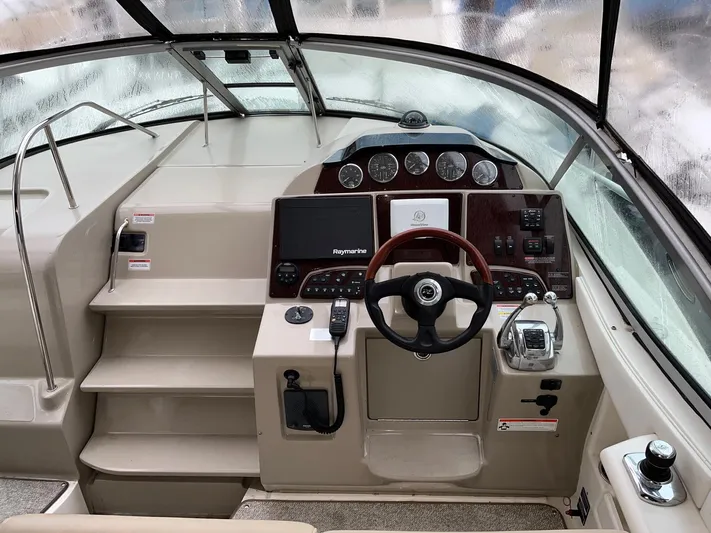 Blue Aye Yacht Photos Pics 2008 Sea Ray 330 Sundancer helm with steering wheel, navigation controls, and instrument panel.