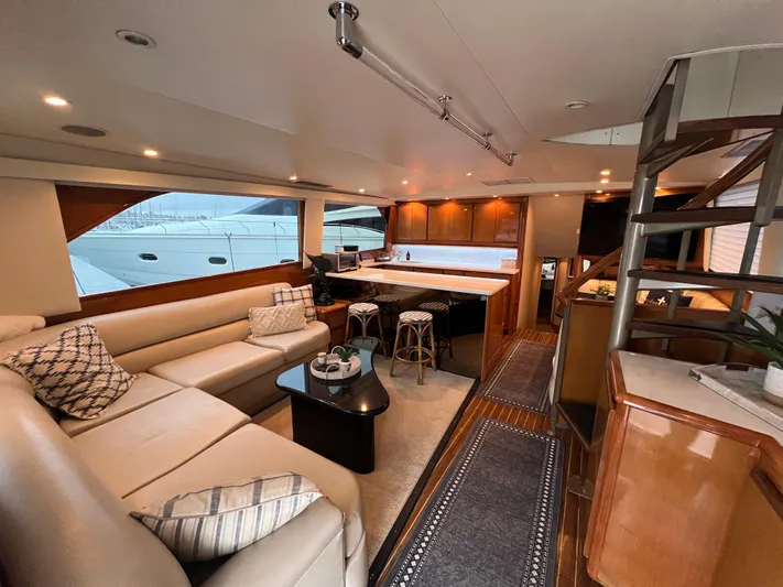 Todo Bien Yacht Photos Pics Luxurious interior of 2000 Viking 58 Enclosed Bridge yacht with modern furnishings and kitchen.