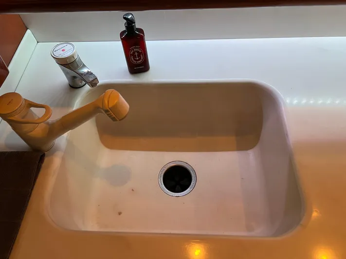 Todo Bien Yacht Photos Pics White sink with faucet and soap bottle on a Viking 58 Enclosed Bridge yacht, 2000 model.