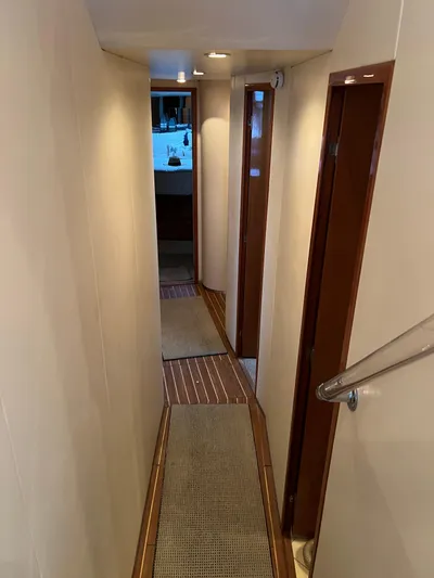 Todo Bien Yacht Photos Pics Narrow hallway inside 2000 Viking 58 Enclosed Bridge yacht with wooden accents.