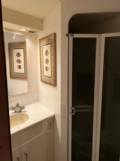 Todo Bien Yacht Photos Pics Bathroom interior of 2000 Viking 58 Enclosed Bridge yacht, featuring sink and shower.