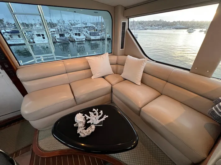 Todo Bien Yacht Photos Pics Luxurious interior of 2000 Viking 58 Enclosed Bridge yacht with plush seating and scenic views.
