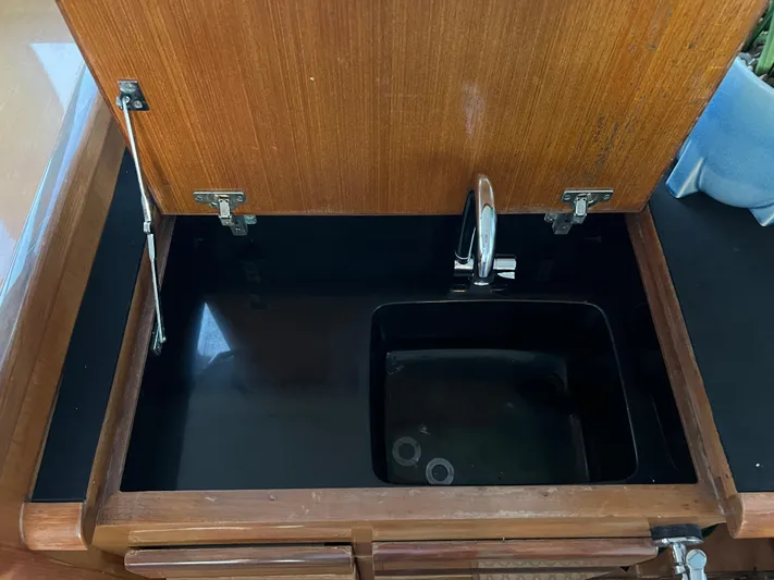 Todo Bien Yacht Photos Pics Wooden cabinet with a built-in sink and faucet on a 2000 Viking 58 Enclosed Bridge yacht.