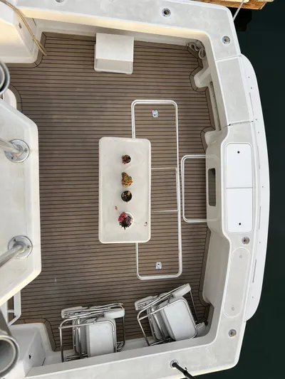 Todo Bien Yacht Photos Pics Viking 58 Enclosed Bridge 2000 yacht deck with chairs and table, aerial view.