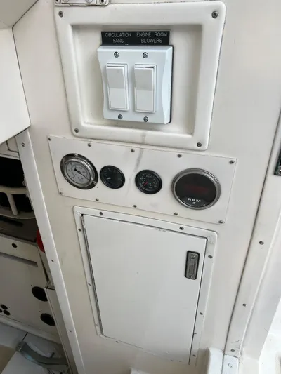 Todo Bien Yacht Photos Pics Control panel on a 2000 Viking 58 Enclosed Bridge yacht, featuring switches and gauges.