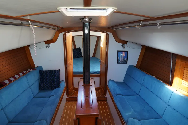  Yacht Photos Pics Interior of 2007 J Boats J/124 sailboat with blue seating and wooden accents.