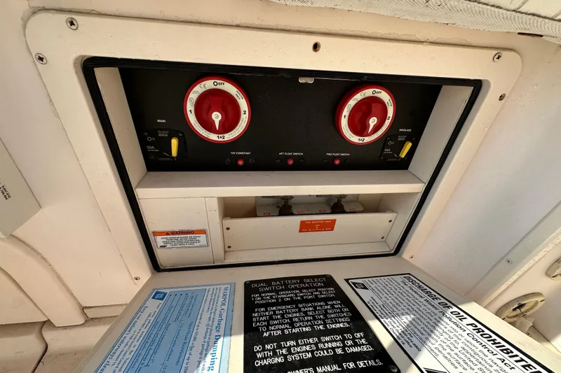 R & R Yacht Photos Pics Control panel of a 2008 Grady White Express boat with battery switches and safety instructions.